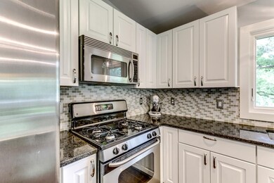 The kitchen features granite countertops and stain