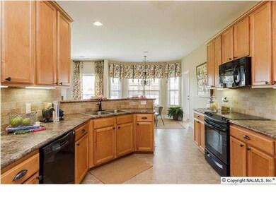 Beautiful maple cabinets & designer selected backsplash make this a kitchen beautiful.