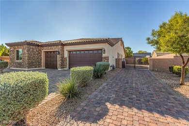 View of front of house featuring a gate, stone siding, decorative driveway, a garage, and stucco siding