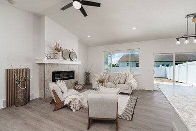 Living area featuring light wood-type flooring, a fireplace, recessed lighting, and lofted ceiling