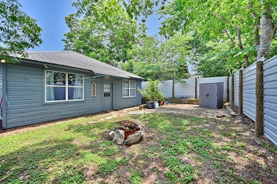 This charming backyard features a cozy single-stor