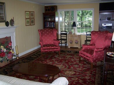 Spacious living room with hardwood flooring and fi