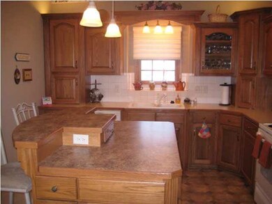 Kitchen with a work island eating bar
