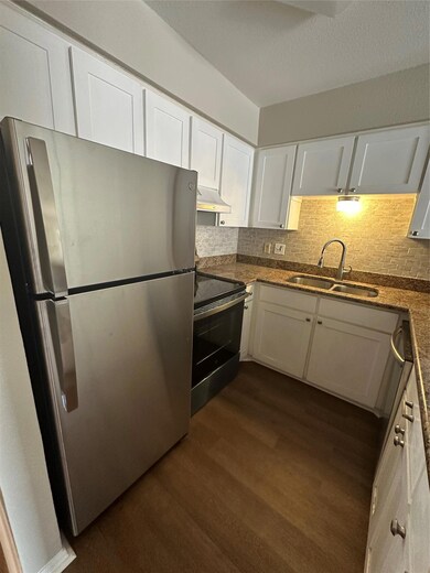 Kitchen featuring fridge, range with electric coo