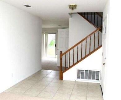 Looking into front entry from the living room to f
