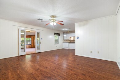 Gorgeous hardwood flooring, doors leading to a sun