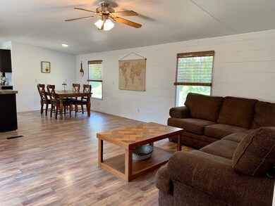 Living room featuring a ceiling fan, a wealth of n