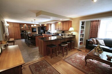 Another view. Wide pine floors, bump-out flanked b