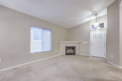 Unfurnished living room with lofted ceiling, baseb