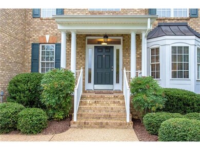 Front entry with aggregate walkway, brick steps an