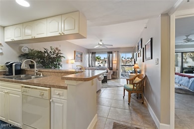 Kitchen featuring a peninsula, dishwasher, a ceili