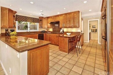 Gourmet kitchen with custom maple cabinets, expans