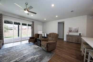 Living room with wood finished floors, ceiling fa