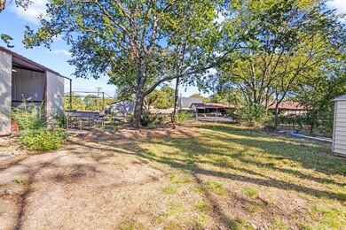 Detached shop with drive through access and double gates to accommodate large vehicles and boats