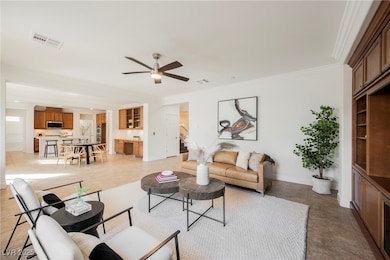 Living area featuring ornamental molding, ceiling