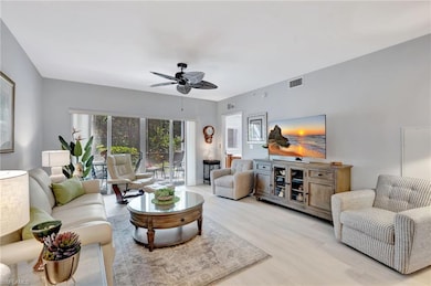 Living room with light wood finished floors, new paint and ceiling fan