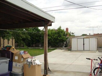 Rear yard with cement slab and covered patio areas