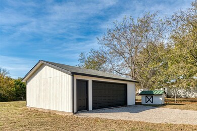 Two garages and a carport provide ample parking fo