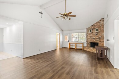 Unfurnished living room with a ceiling fan, high v