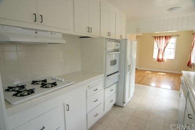 Kitchen with new cook top & vent hood plus refrige