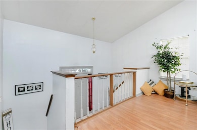 Staircase featuring lofted ceiling and hardwood / 
