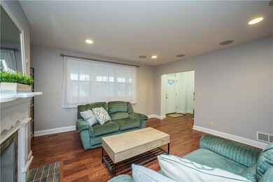 The living room is open to the front door, hallway