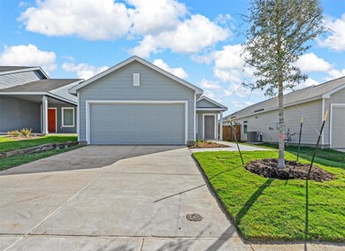 Ranch-style house featuring a front yard and a gar