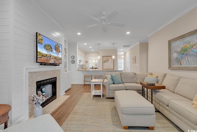 Living room with ornamental molding, a tiled firep