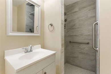 first floor bathroom featuring walk in shower that
