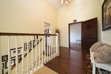Entryway showcasing beautiful hardwood front door.