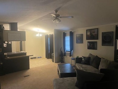 Carpeted living room with ceiling fan with notable