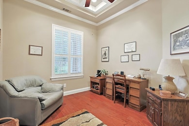 Home office with ornamental molding, hardwood floo