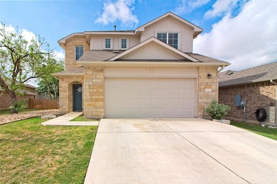 Traditional home featuring concrete driveway, sto
