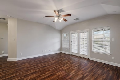 Unfurnished room featuring lofted ceiling, a ceil