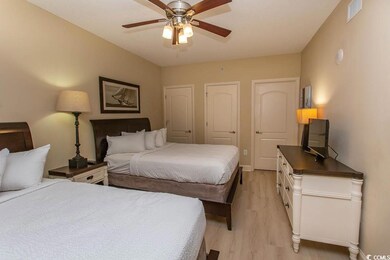 Bedroom with ceiling fan and light hardwood / wood