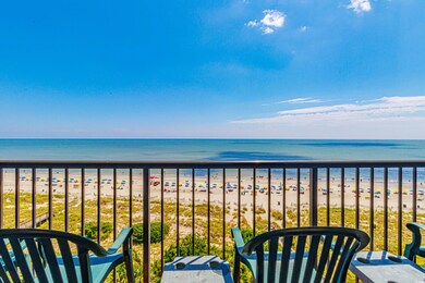 Balcony featuring a beach view and a water view