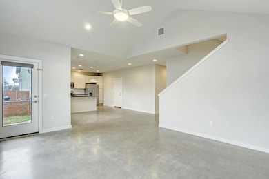Unfurnished living room featuring concrete floori