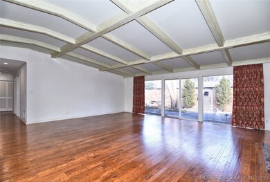 Living area with large glass windows onto patio
