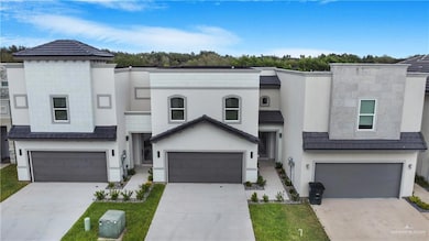 View of front of house featuring stucco siding and concrete driveway