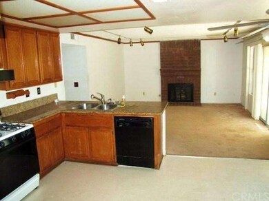 Kitchen open to family room with fireplace