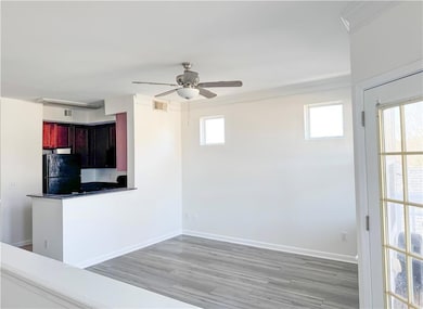 Living Room and Kitchen view with black refrigerat