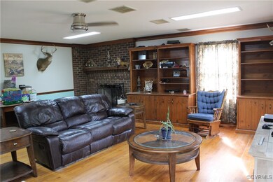 Living room with light wood-type flooring, crown m