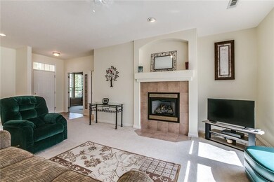 Open floor plan to kitchen and dining with gas log fireplace.