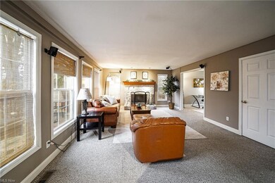 Large family room with gas fireplace open to the e