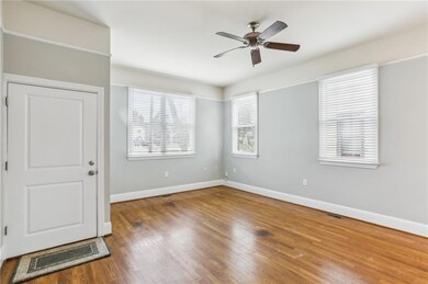 Empty room with ceiling fan and wood finished floors