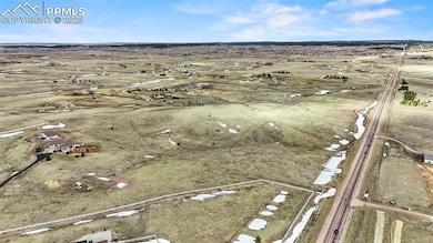 Birds eye view of property featuring a rural view