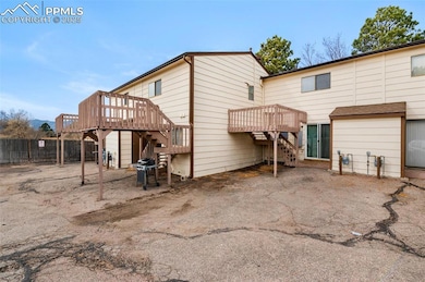 Back of house with stairway and a wooden deck
