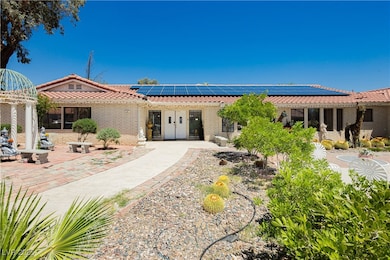 Rear view of property featuring a tile roof, roof