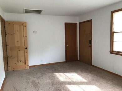 Living room has a nice coat closet and very large picture window.