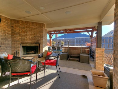 View of patio featuring an outdoor living space with a fireplace and fence